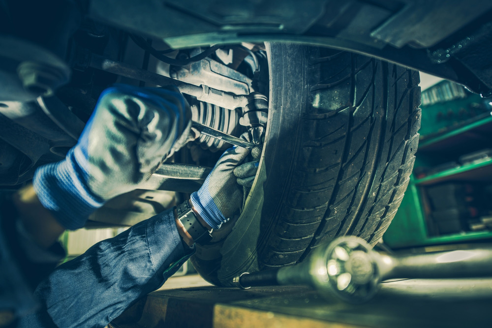 Car Mechanic Fixing Steering System