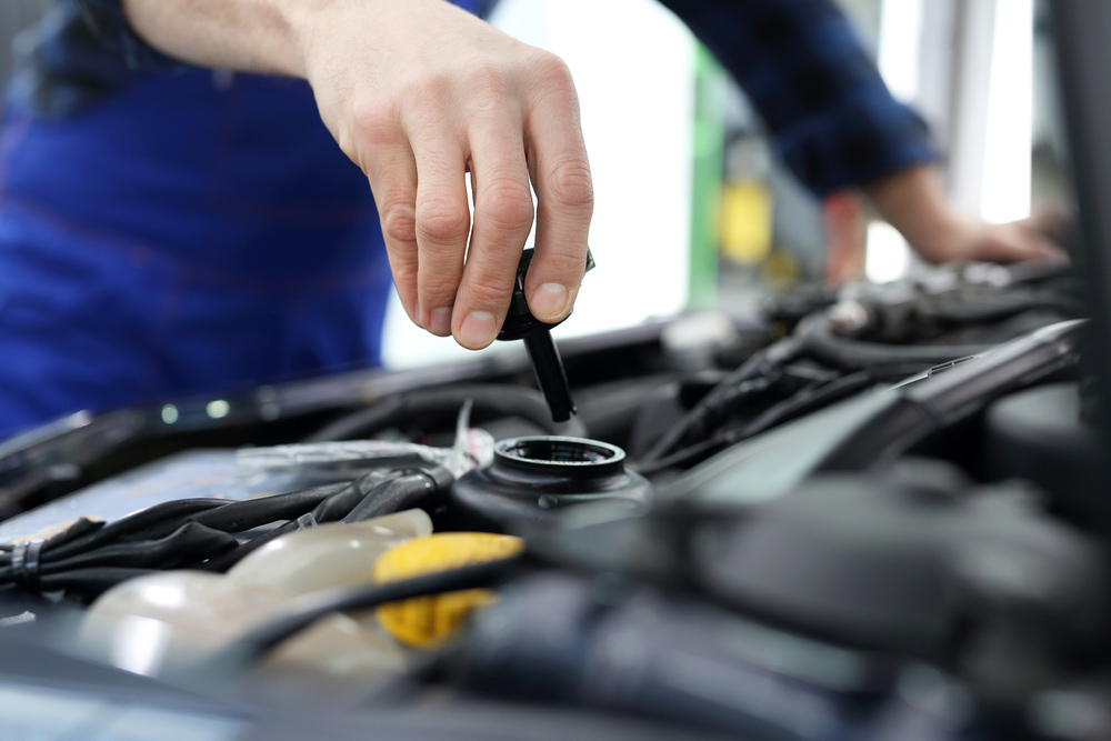 A Mechanic Checking Vehicle Fluid